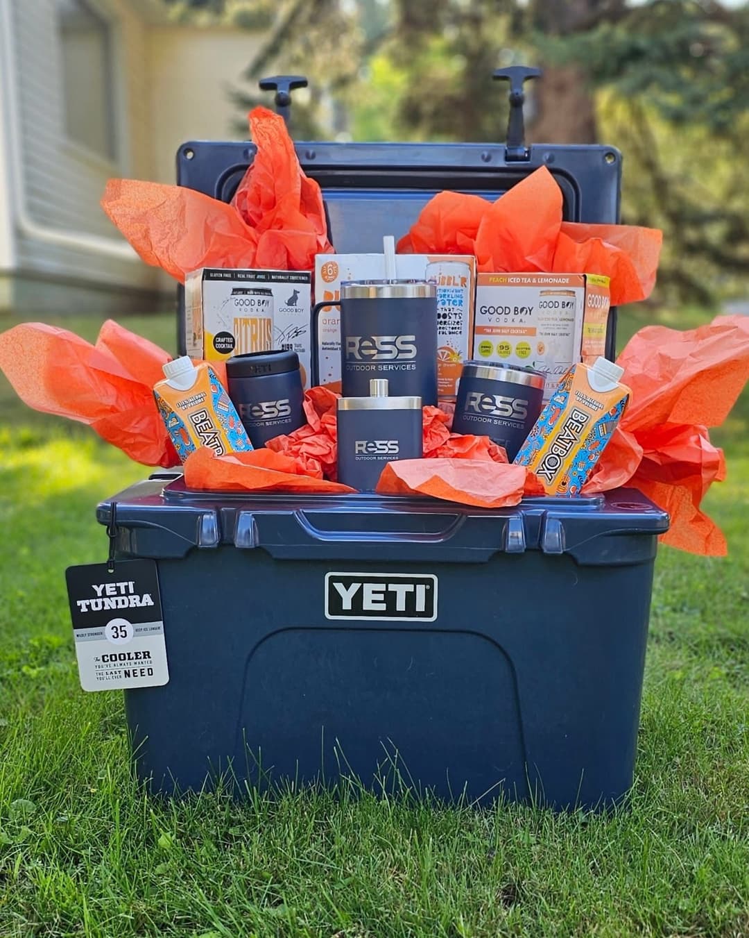 YETI Tundra cooler filled with colorful snacks, drinks, and accessories in outdoor setting.